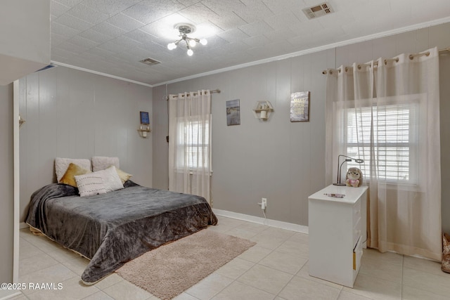 bedroom with visible vents, baseboards, crown molding, and light tile patterned flooring