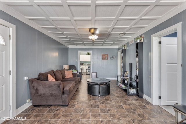 living room with stone finish flooring, wooden walls, and baseboards
