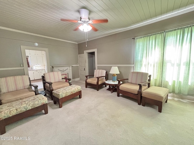 carpeted living room featuring ceiling fan and ornamental molding