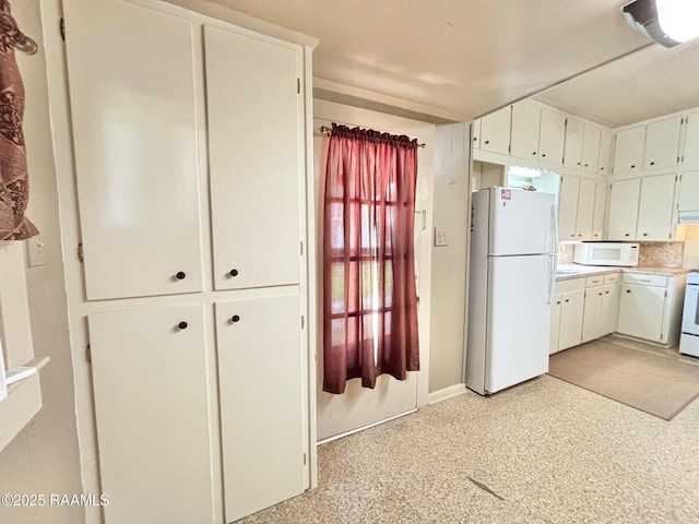 kitchen with light countertops, baseboards, white cabinets, ventilation hood, and white appliances