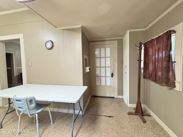 interior space featuring baseboards and ornamental molding