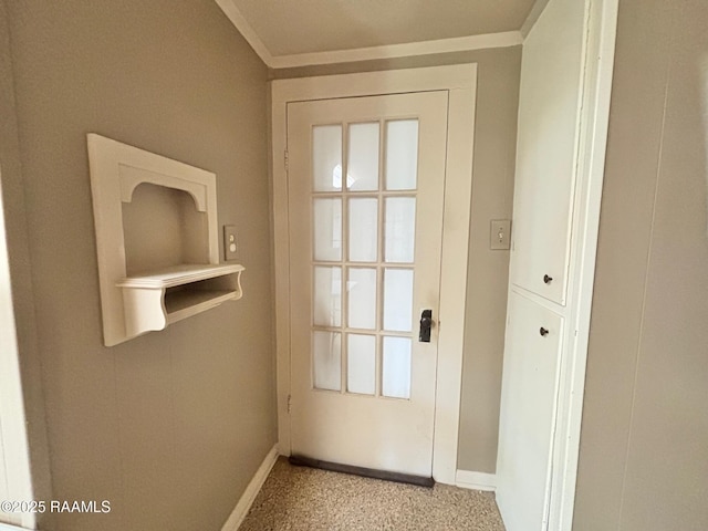 doorway featuring crown molding, baseboards, and light carpet
