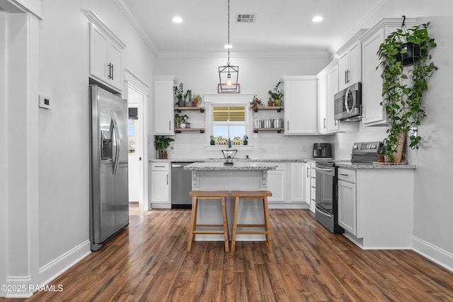 kitchen with open shelves, a kitchen island, visible vents, decorative backsplash, and appliances with stainless steel finishes
