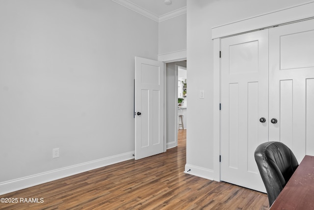 home office featuring ornamental molding, baseboards, and wood finished floors