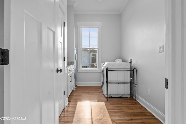 washroom featuring laundry area, crown molding, washer / clothes dryer, wood finished floors, and baseboards