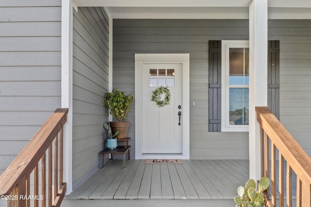 view of exterior entry with a porch