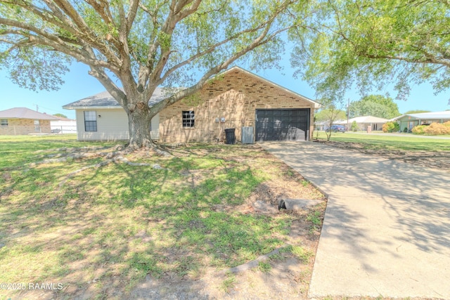 view of front of house featuring a garage, a front yard, brick siding, and driveway