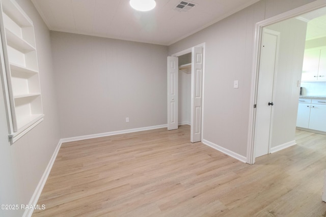 unfurnished bedroom featuring visible vents, baseboards, and light wood finished floors