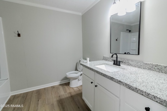 bathroom featuring crown molding, vanity, toilet, wood finished floors, and walk in shower