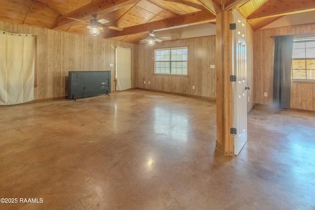unfurnished living room with finished concrete flooring, lofted ceiling with beams, a ceiling fan, wood ceiling, and wood walls