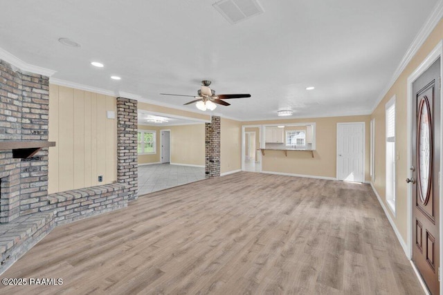 7848 Lake St, Lake Charles, LA 70605 - unfurnished living room featuring light wood finished floors, visible vents, baseboards, and ornamental molding