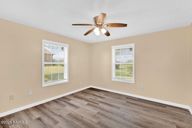 7848 Lake St, Lake Charles, LA 70605 - unfurnished room with plenty of natural light, baseboards, a ceiling fan, and wood finished floors