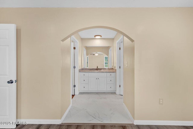 7848 Lake St, Lake Charles, LA 70605 - corridor featuring arched walkways, a sink, marble finish floor, and baseboards