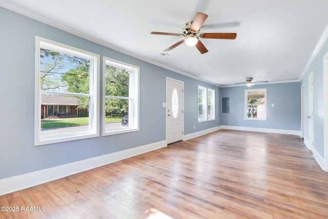 unfurnished living room featuring a ceiling fan, baseboards, crown molding, and wood finished floors