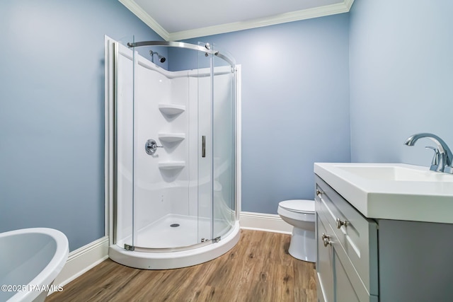 bathroom with baseboards, wood finished floors, crown molding, and a stall shower