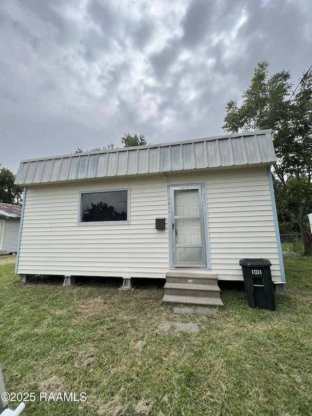 1009/1011 Providence St, New Iberia, LA 70560 - back of house with a yard, entry steps, an outdoor structure, and metal roof