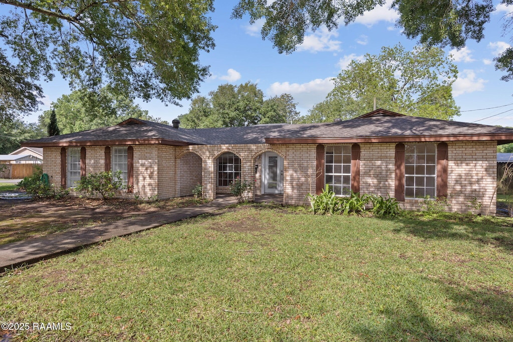 single story home with a front lawn and brick siding