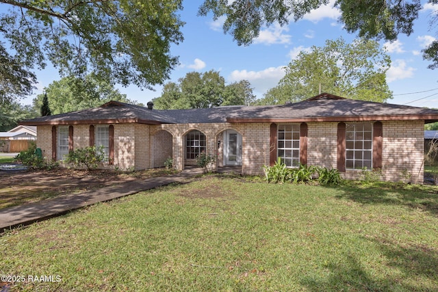 single story home with a front lawn and brick siding