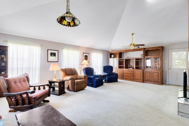 living area featuring high vaulted ceiling, carpet, and ceiling fan