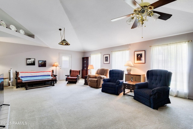 carpeted living room featuring a ceiling fan and vaulted ceiling