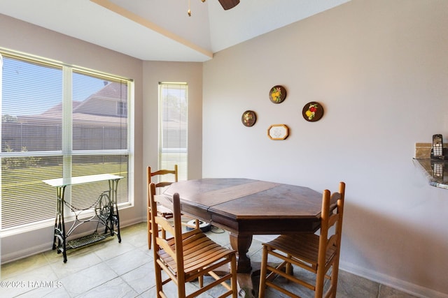 dining room featuring vaulted ceiling, baseboards, a ceiling fan, and light tile patterned flooring