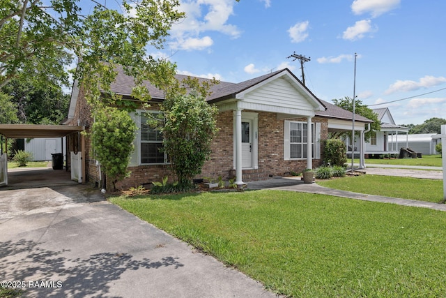 311 S Morgan Ave, Broussard, LA 70518 - view of front of house with brick siding, driveway, a carport, a front lawn, and a shingled roof