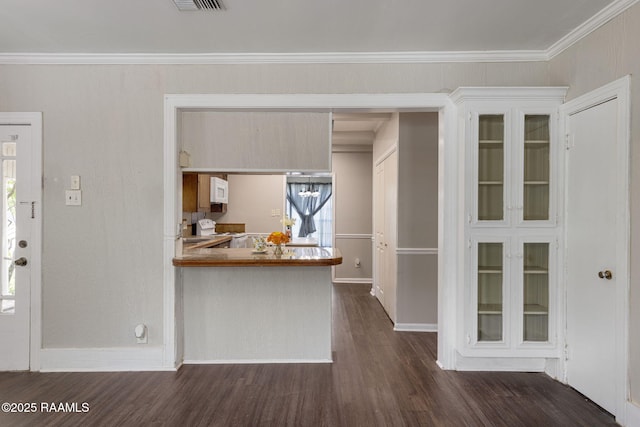 311 S Morgan Ave, Broussard, LA 70518 - kitchen with glass insert cabinets, visible vents, baseboards, ornamental molding, and dark wood-style floors