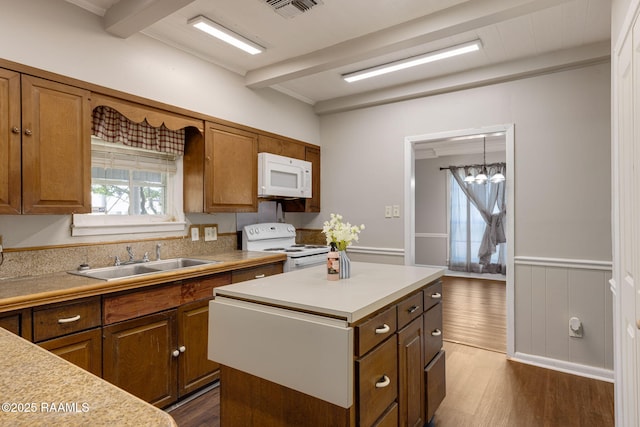 311 S Morgan Ave, Broussard, LA 70518 - kitchen with white appliances, light countertops, beam ceiling, and a sink
