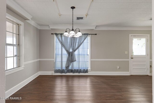 311 S Morgan Ave, Broussard, LA 70518 - unfurnished dining area with ornamental molding, baseboards, visible vents, dark wood-style flooring, and a notable chandelier