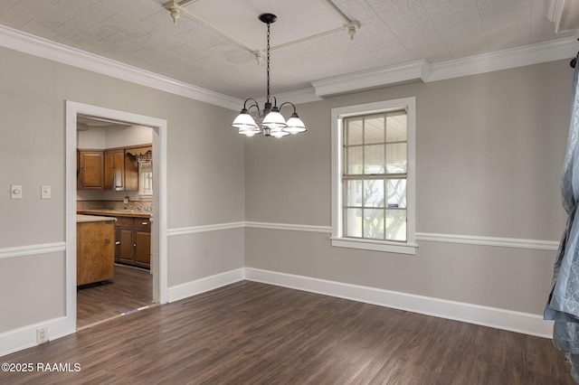 311 S Morgan Ave, Broussard, LA 70518 - unfurnished dining area with dark wood-style flooring, ornamental molding, baseboards, and a chandelier