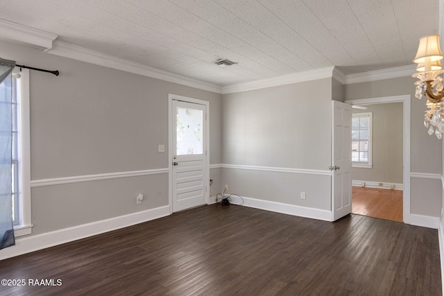 311 S Morgan Ave, Broussard, LA 70518 - unfurnished room featuring ornamental molding, dark wood-type flooring, visible vents, a chandelier, and baseboards