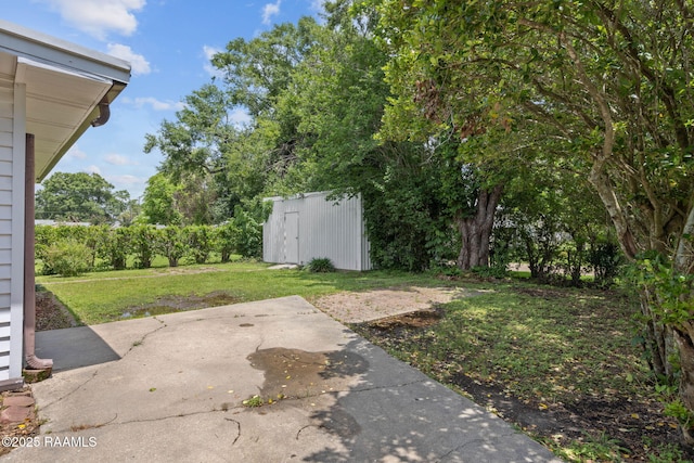 311 S Morgan Ave, Broussard, LA 70518 - view of yard featuring a patio, an outbuilding, and a shed