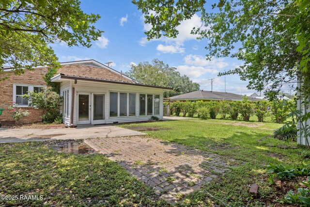 311 S Morgan Ave, Broussard, LA 70518 - back of property with a lawn and a patio