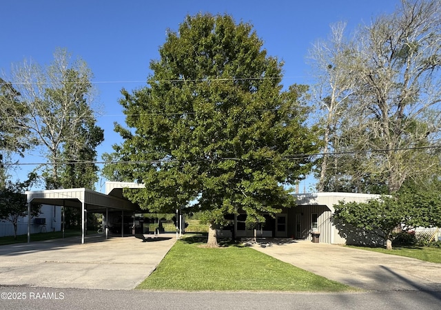 view of front of home featuring a carport, a front yard, and concrete driveway