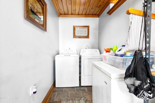 washroom featuring laundry area, crown molding, wooden ceiling, washing machine and clothes dryer, and baseboards
