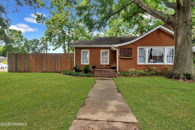 1703 W University Ave, Lafayette, LA 70506 - view of front of property featuring brick siding, fence, a shingled roof, and a front yard