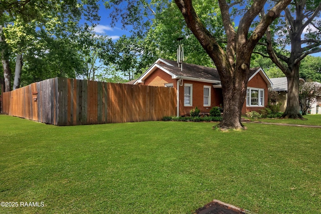 1703 W University Ave, Lafayette, LA 70506 - view of front of house featuring brick siding, fence, and a front yard