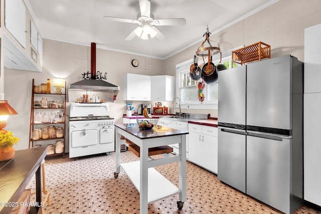 1703 W University Ave, Lafayette, LA 70506 - kitchen with white cabinets, freestanding refrigerator, a ceiling fan, white gas stove, and ornamental molding