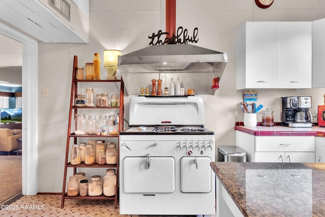 1703 W University Ave, Lafayette, LA 70506 - kitchen with tile countertops, white cabinetry, and white gas range