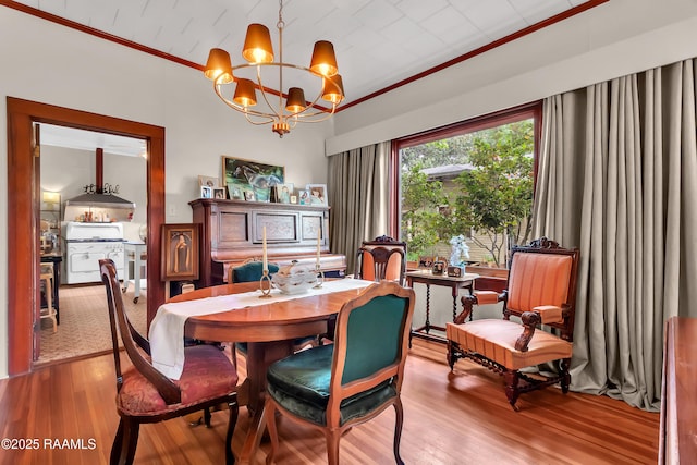 1703 W University Ave, Lafayette, LA 70506 - dining room with crown molding, light wood finished floors, and a notable chandelier