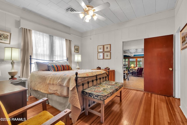 1703 W University Ave, Lafayette, LA 70506 - bedroom with a decorative wall, hardwood / wood-style flooring, and visible vents