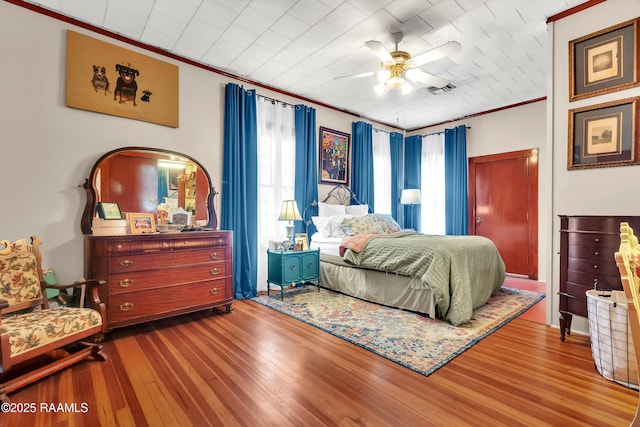 1703 W University Ave, Lafayette, LA 70506 - bedroom featuring crown molding, a ceiling fan, visible vents, and hardwood / wood-style flooring