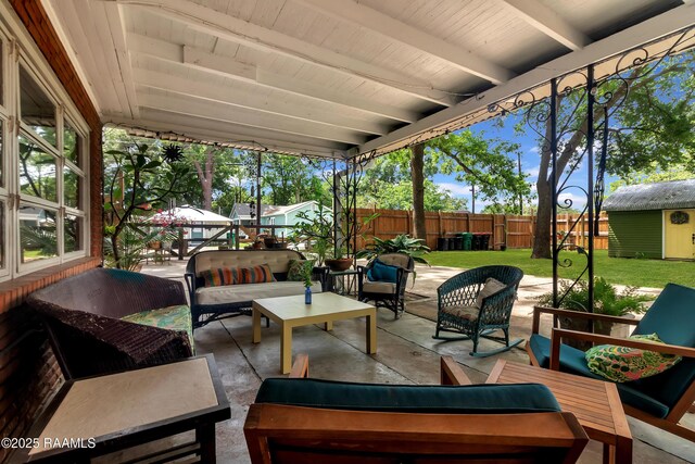 1703 W University Ave, Lafayette, LA 70506 - view of patio featuring a fenced backyard, an outdoor structure, and outdoor lounge area