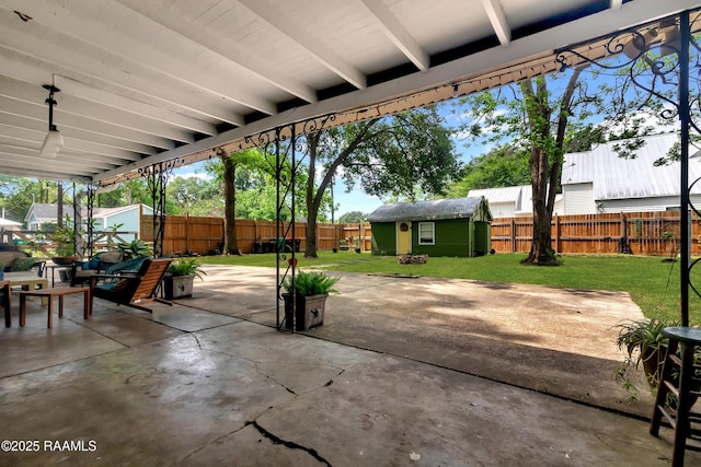 1703 W University Ave, Lafayette, LA 70506 - view of patio featuring a fenced backyard, a storage unit, and an outbuilding