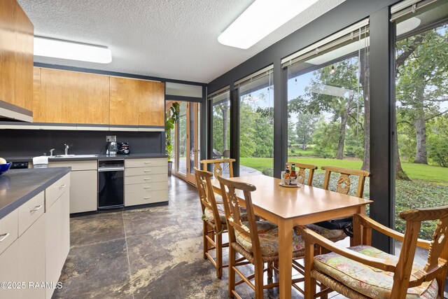 1 Eureka Plantation Rd, Lafayette, LA 70508 - kitchen with plenty of natural light, dark countertops, a textured ceiling, and a sink