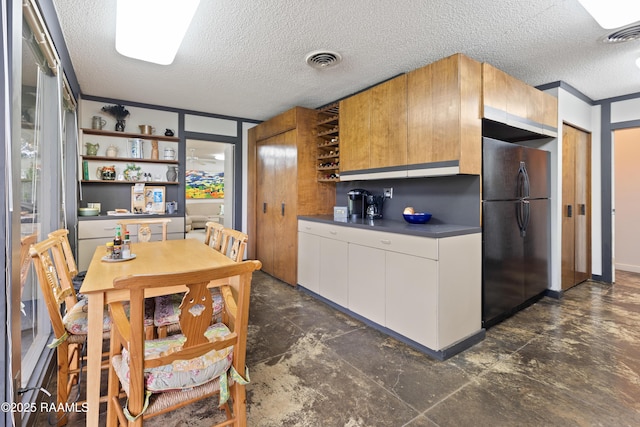 1 Eureka Plantation Rd, Lafayette, LA 70508 - kitchen featuring freestanding refrigerator, open shelves, dark countertops, a textured ceiling, and white cabinetry