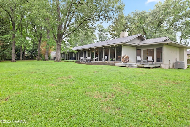 1 Eureka Plantation Rd, Lafayette, LA 70508 - back of house featuring a sunroom, a lawn, a chimney, and central AC
