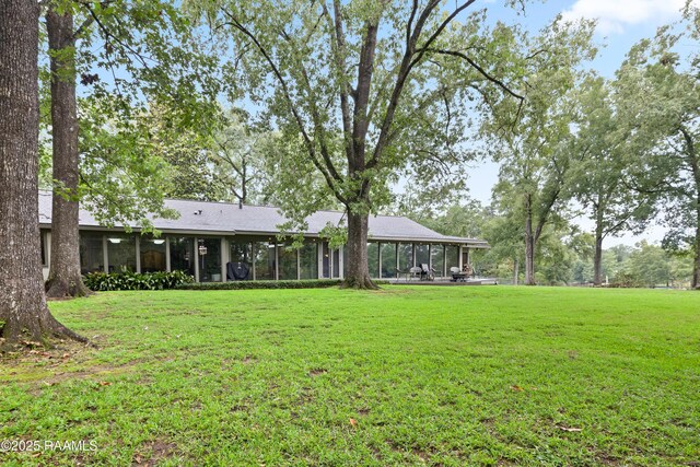 1 Eureka Plantation Rd, Lafayette, LA 70508 - rear view of property featuring a sunroom and a lawn