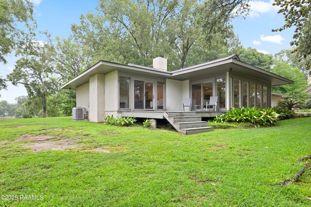 1 Eureka Plantation Rd, Lafayette, LA 70508 - rear view of property with central AC unit, a lawn, a sunroom, and stucco siding