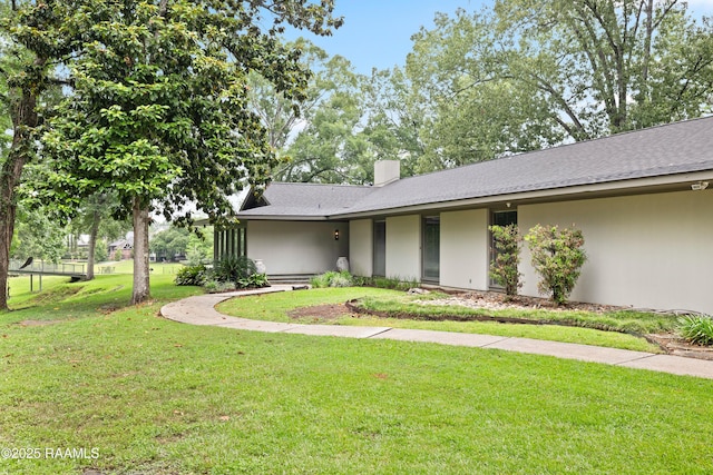 1 Eureka Plantation Rd, Lafayette, LA 70508 - view of front of house with a front lawn, stucco siding, and a chimney